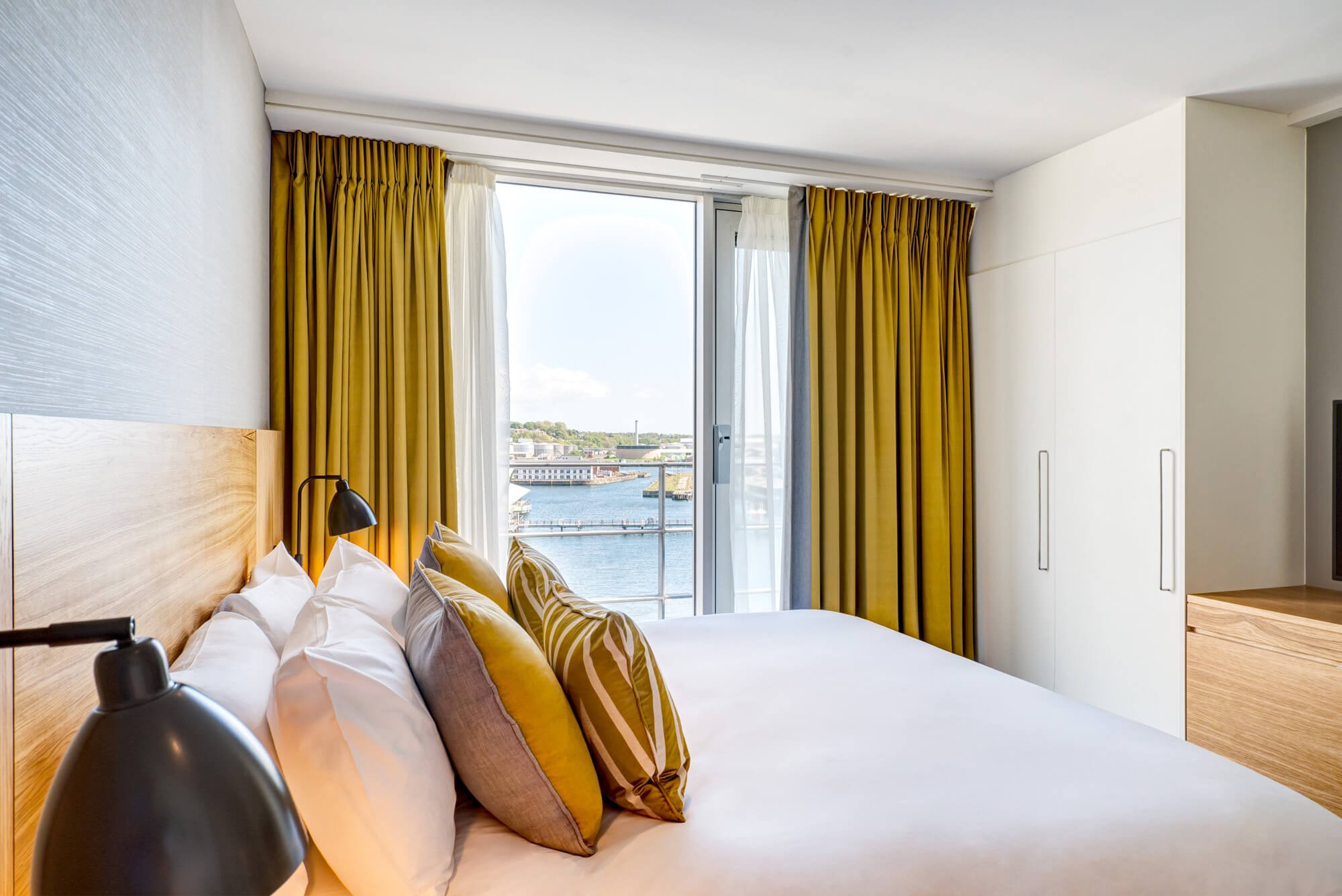 Master suite bedroom with quay view at Apex City Quay Hotel