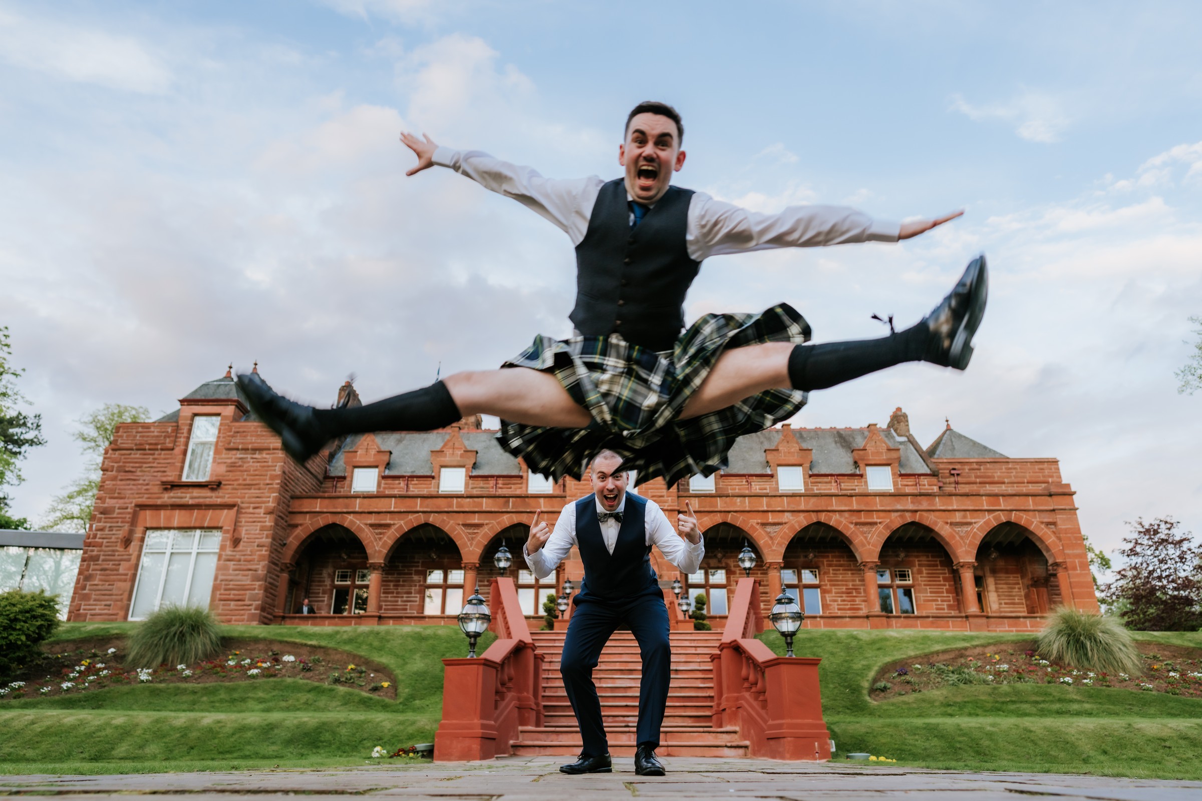 Celebratory wedding portrait in front of Boclair House