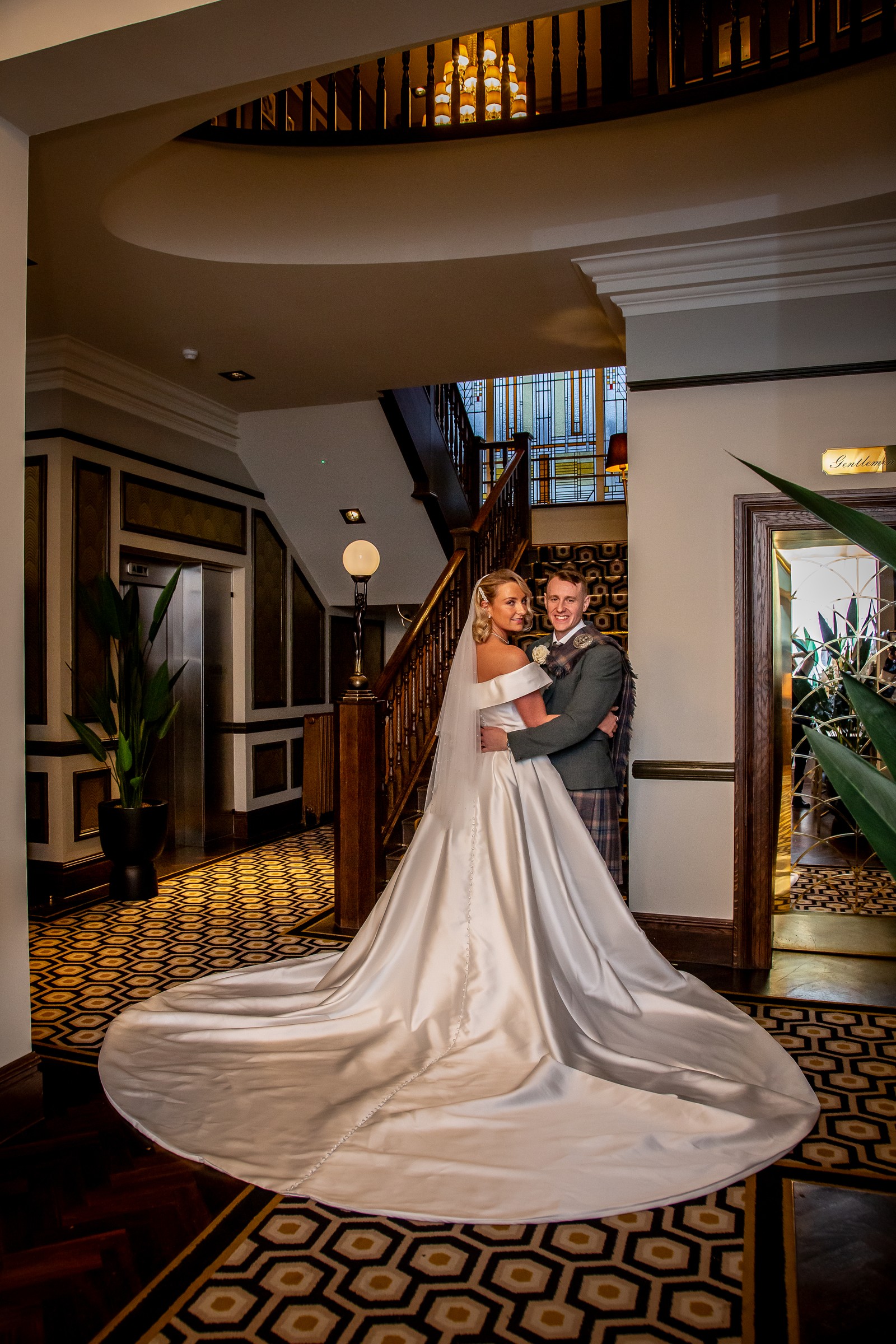 Newly married couple on the staircase at Boclair House