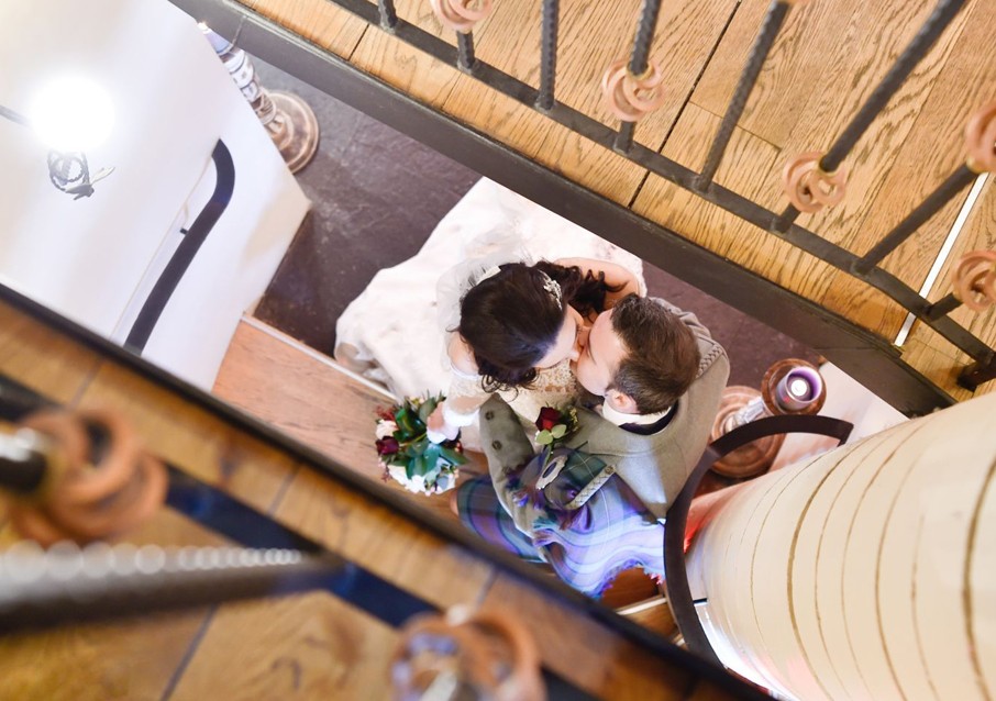 Overhead view of newlyweds on Glenskirlie’s staircase.
