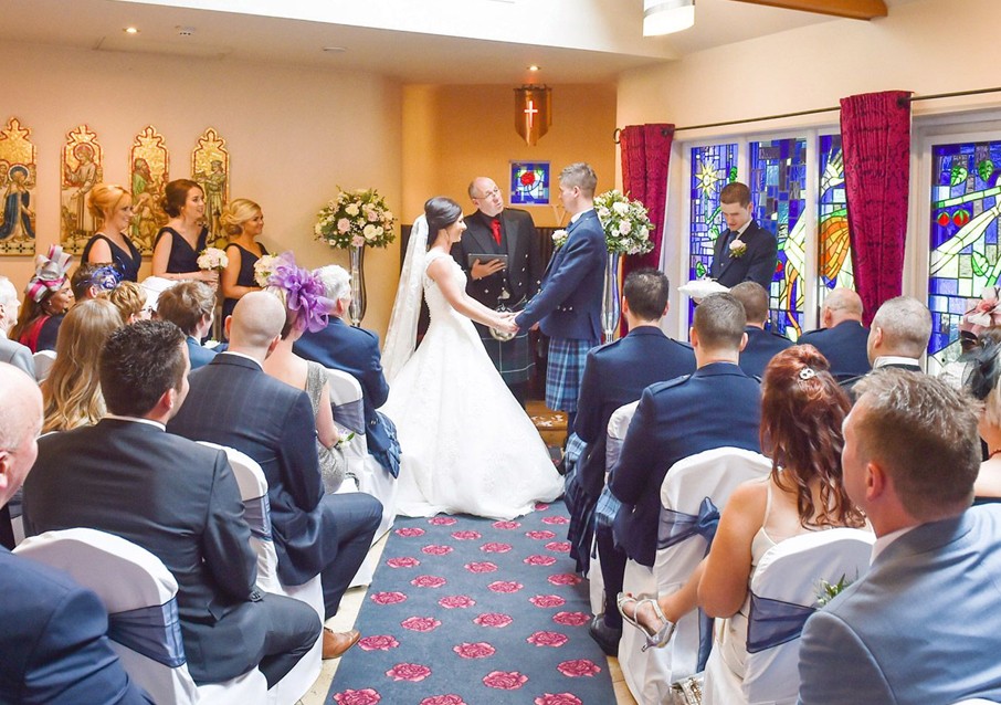 Indoor wedding ceremony at Glenskirlie Castle Hotel.
