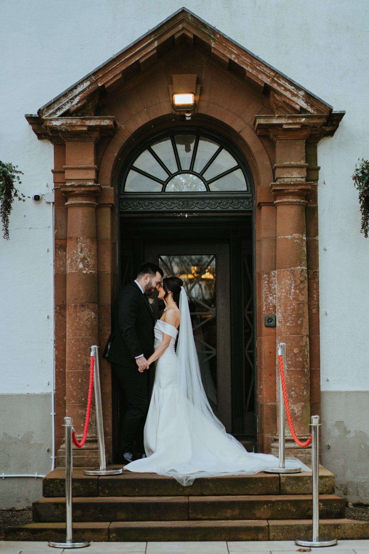 Bride framed in Hetland Hall’s stone entrance.